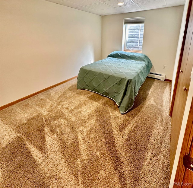 bedroom with baseboard heating, carpet flooring, and a paneled ceiling