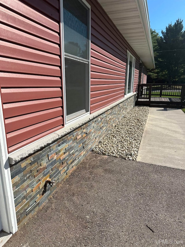 view of side of property featuring a deck