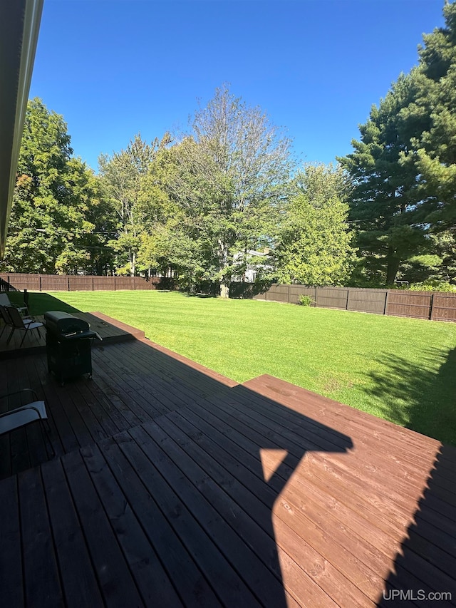 wooden deck featuring a yard