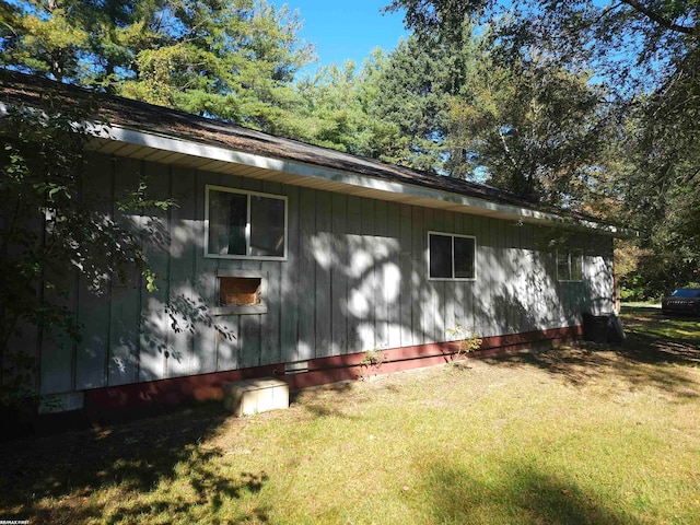 view of side of home with a lawn