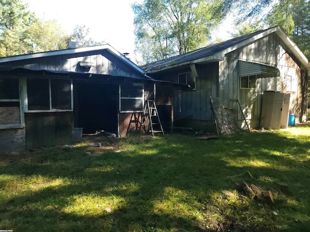 rear view of property with a yard