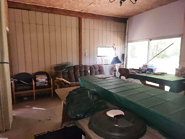 miscellaneous room featuring wood walls and carpet