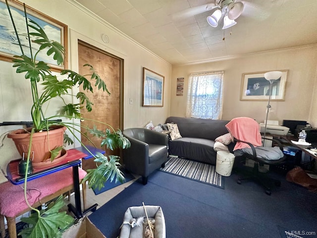 carpeted living room with ornamental molding and ceiling fan