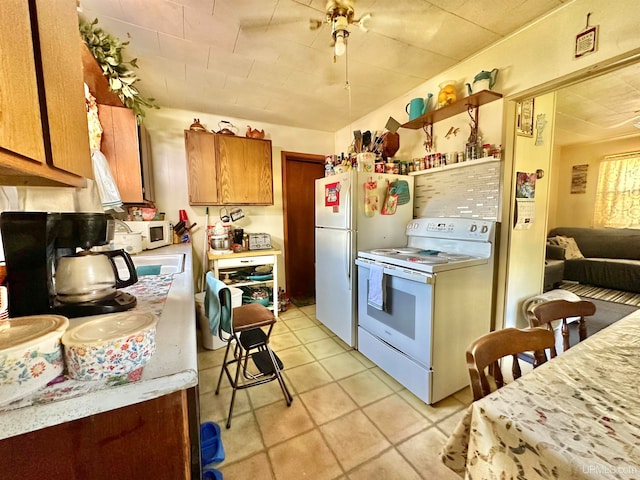 kitchen featuring white appliances and ceiling fan