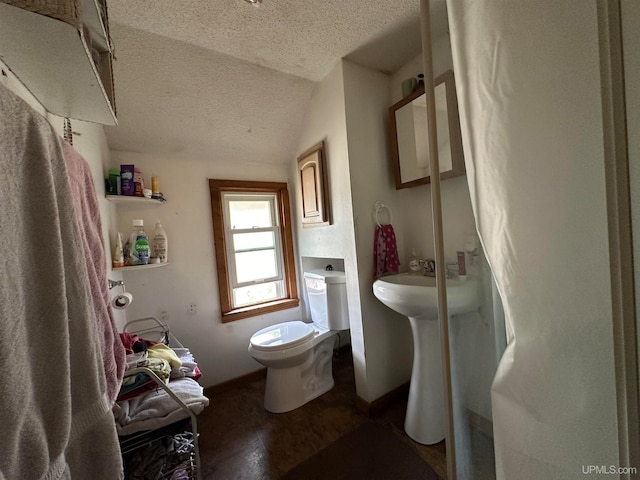 bathroom with toilet, sink, and a textured ceiling