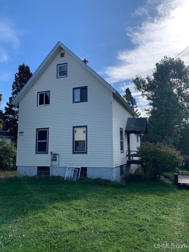 view of property exterior with a lawn