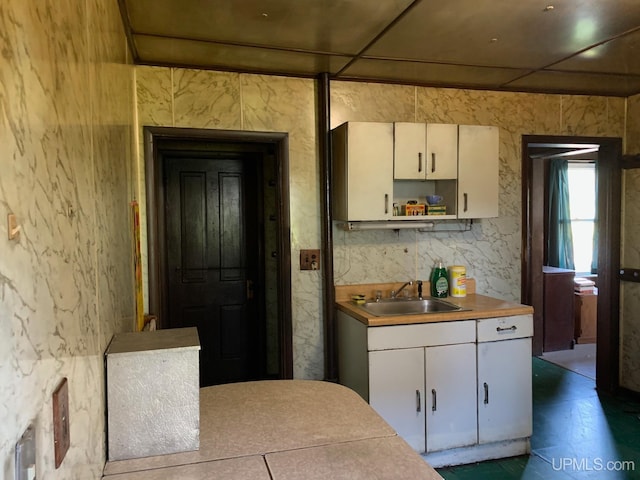 kitchen with sink and white cabinetry