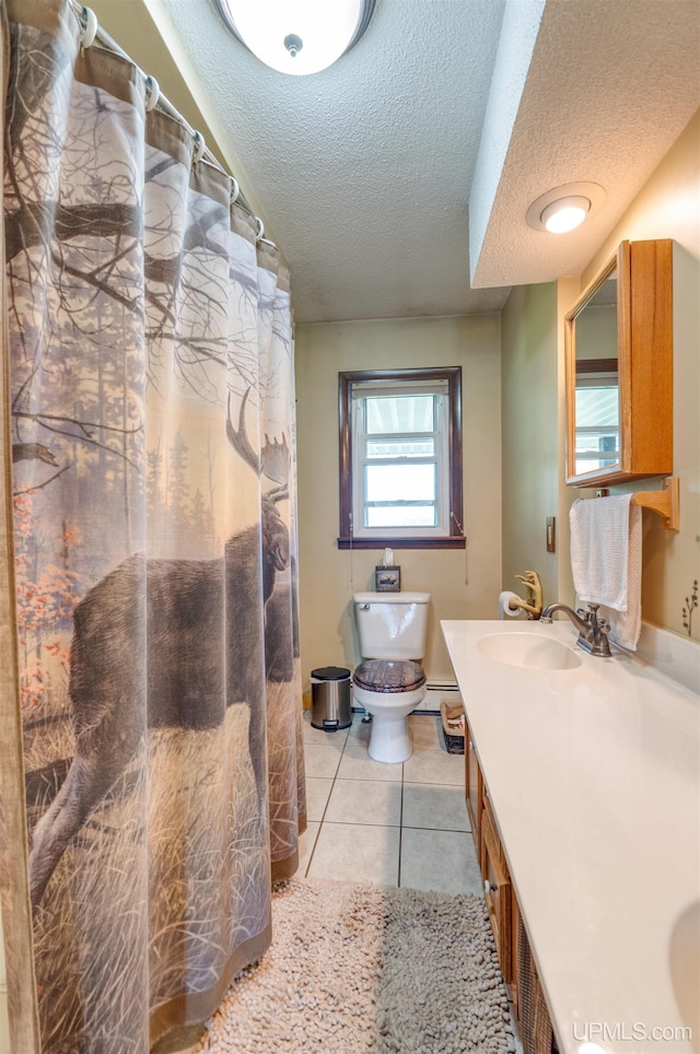 bathroom featuring vanity, a textured ceiling, tile patterned flooring, toilet, and a baseboard heating unit