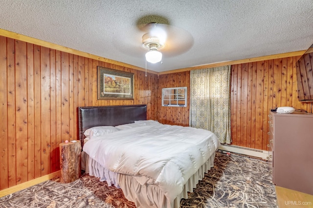 bedroom featuring ceiling fan, a textured ceiling, wooden walls, and baseboard heating