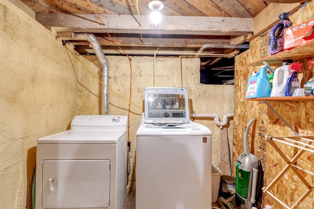 clothes washing area featuring washer and clothes dryer