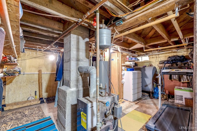 basement featuring washer / clothes dryer and water heater