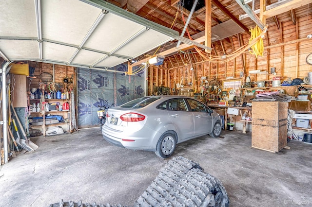 garage with a garage door opener and a workshop area