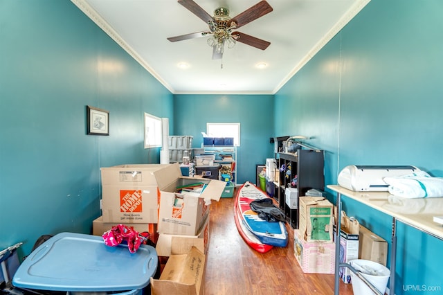 game room with ornamental molding, ceiling fan, and hardwood / wood-style flooring