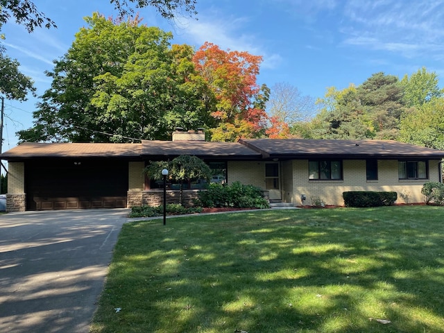 view of front of house featuring a garage and a front lawn