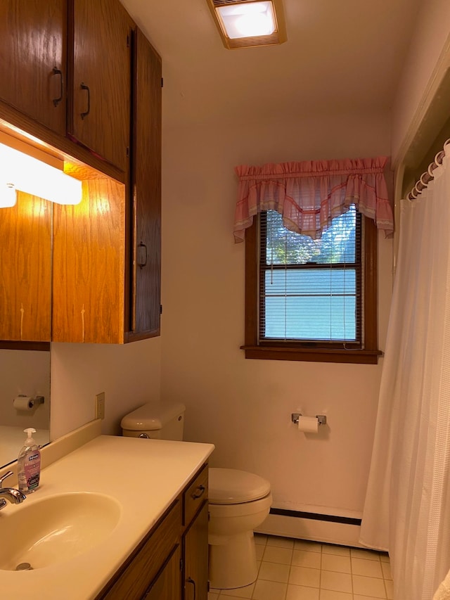 bathroom featuring tile patterned flooring, vanity, toilet, and a baseboard radiator