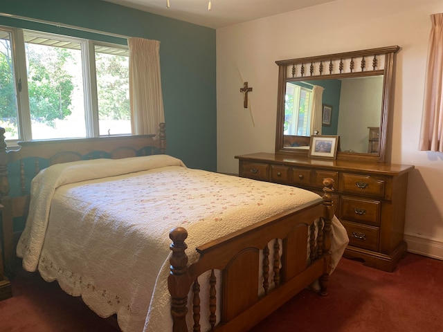 bedroom featuring dark carpet