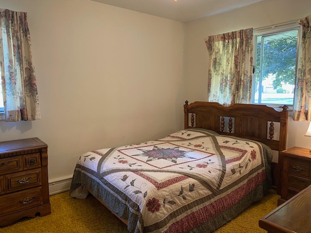 carpeted bedroom featuring a baseboard heating unit