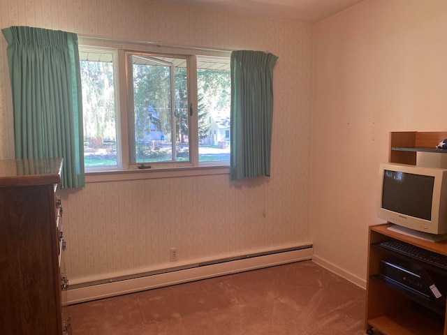 bedroom with baseboard heating and carpet flooring