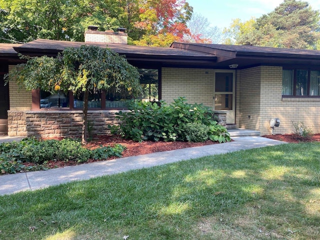 doorway to property with a yard