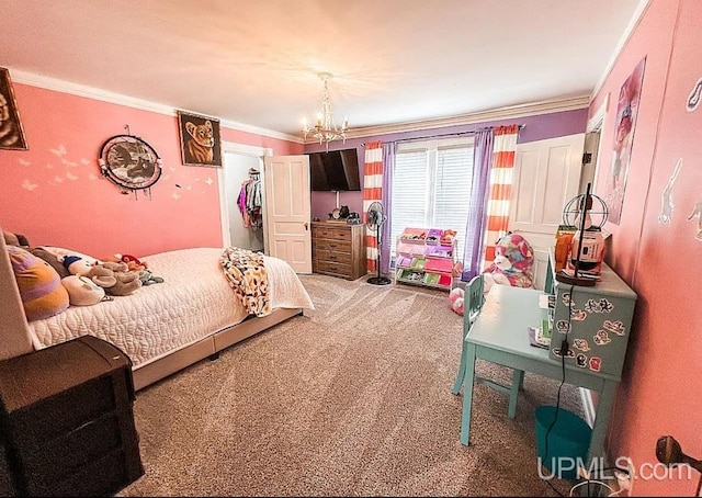 carpeted bedroom with crown molding, a chandelier, a walk in closet, and a closet