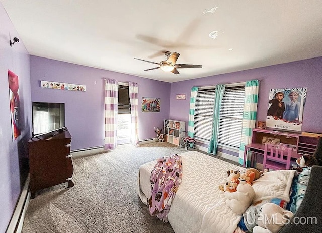 bedroom with multiple windows, baseboard heating, ceiling fan, and carpet floors