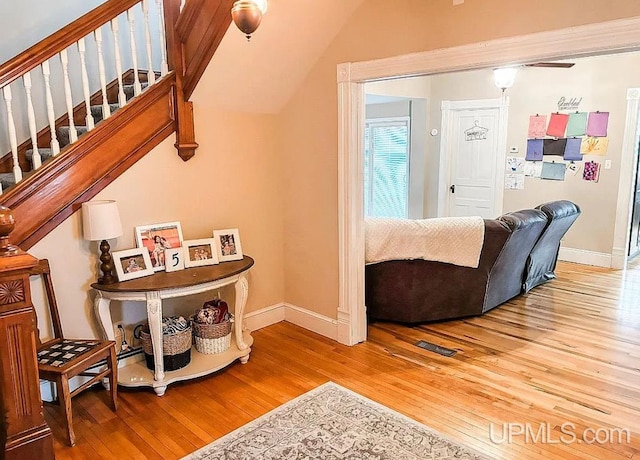 living room featuring vaulted ceiling and hardwood / wood-style floors