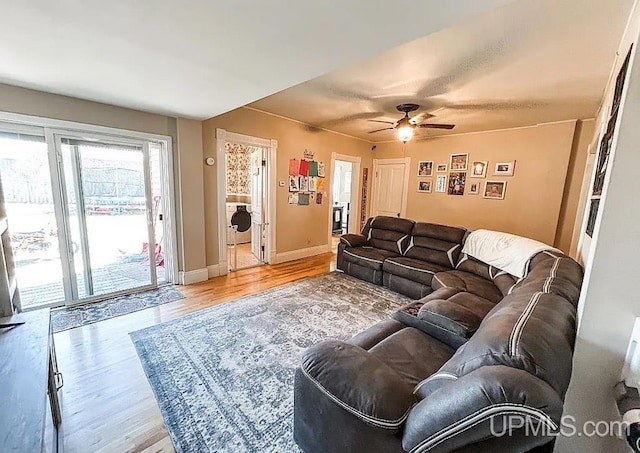 living room featuring washer / clothes dryer, ceiling fan, and hardwood / wood-style flooring