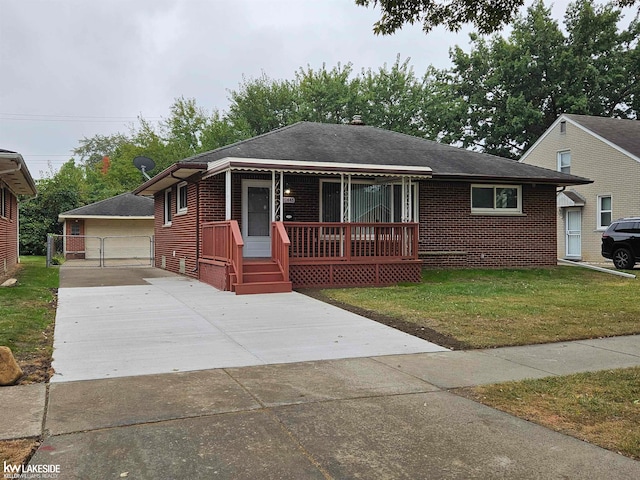 view of front facade featuring a garage, a front lawn, and an outbuilding