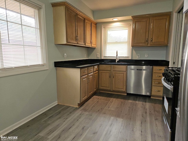 kitchen featuring hardwood / wood-style flooring, sink, gas stove, and stainless steel dishwasher