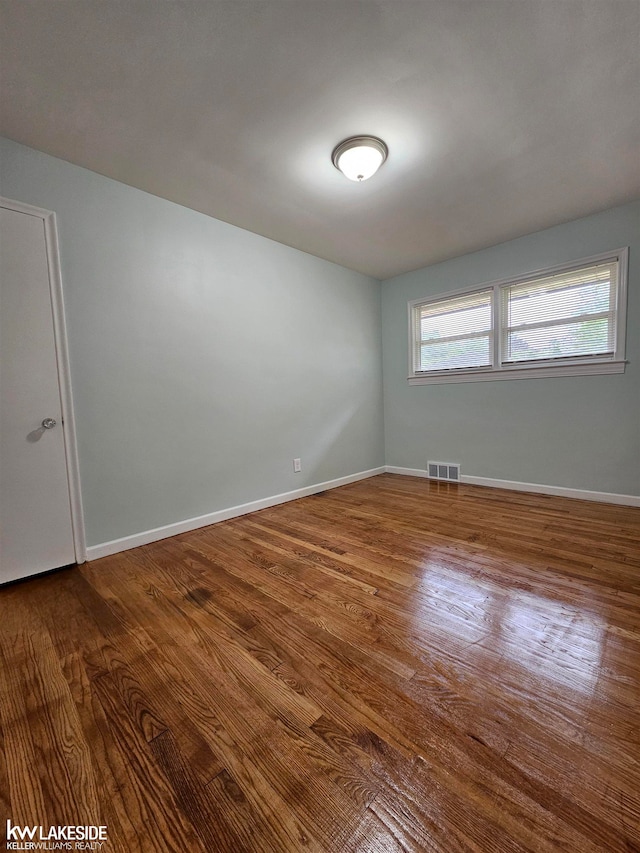 unfurnished room featuring wood-type flooring