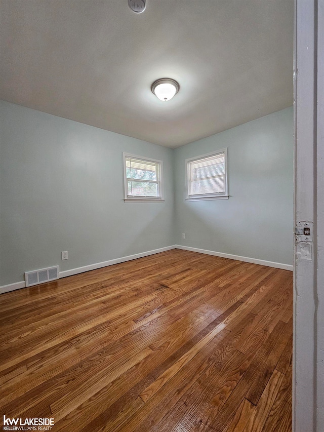 empty room with hardwood / wood-style floors