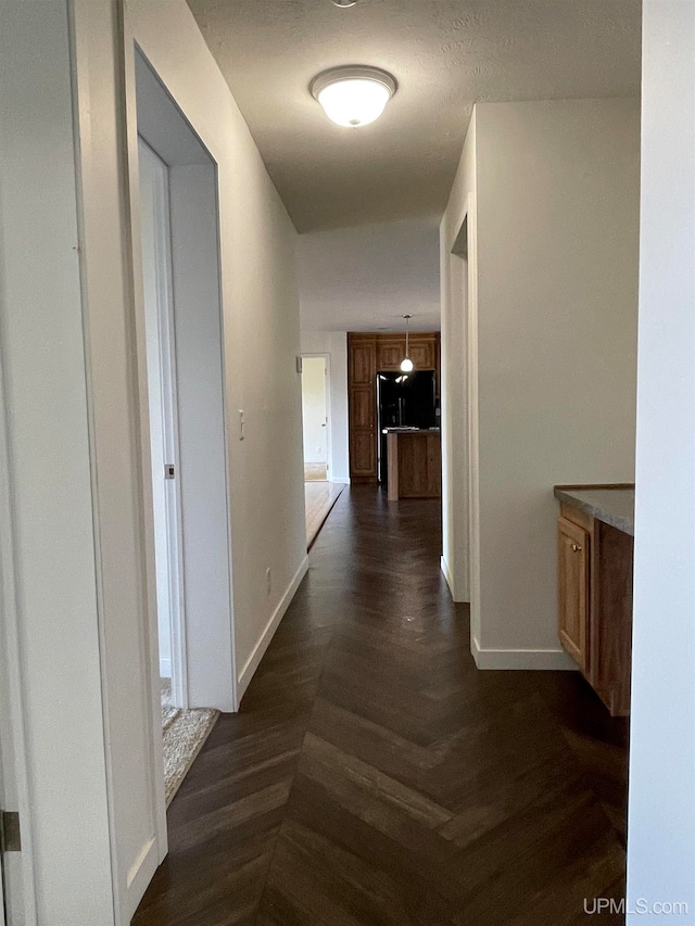 hallway with dark parquet floors