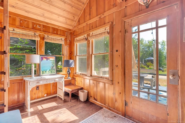 sunroom / solarium featuring wooden ceiling, a healthy amount of sunlight, and lofted ceiling