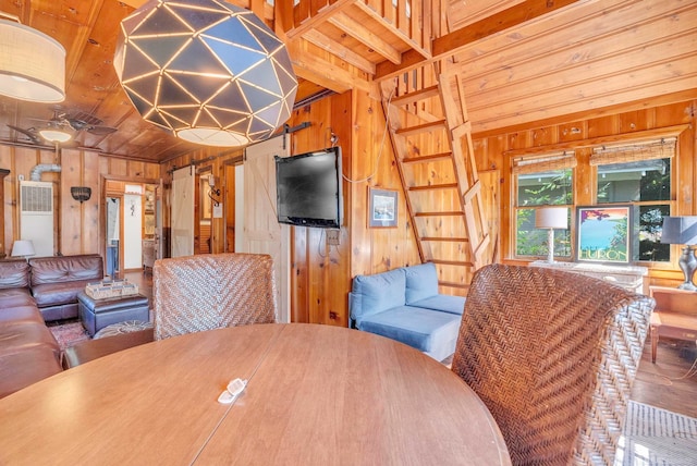 dining room with wood ceiling and wood walls