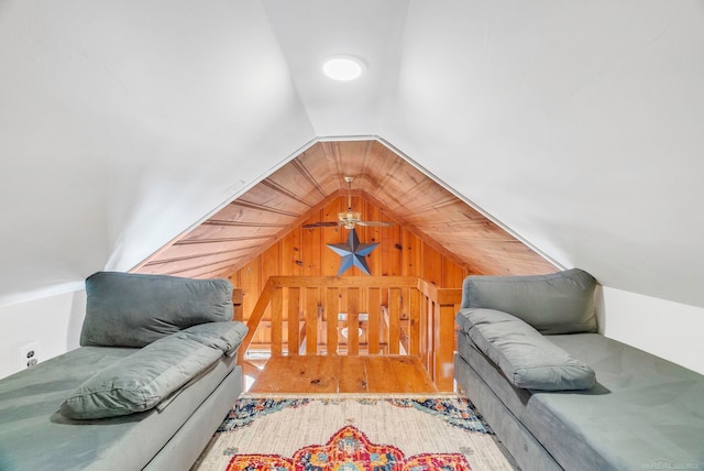 living room featuring lofted ceiling, ceiling fan, wood walls, and hardwood / wood-style flooring