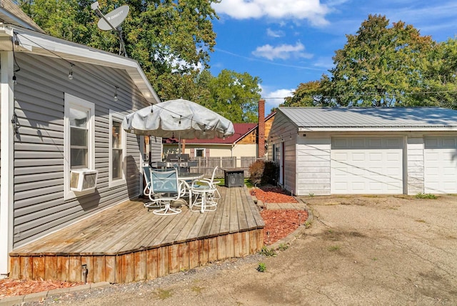 wooden deck featuring an outbuilding and a garage