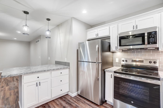 kitchen featuring hanging light fixtures, white cabinets, kitchen peninsula, dark hardwood / wood-style flooring, and stainless steel appliances