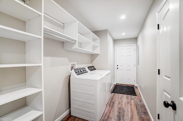 washroom featuring separate washer and dryer and dark wood-type flooring