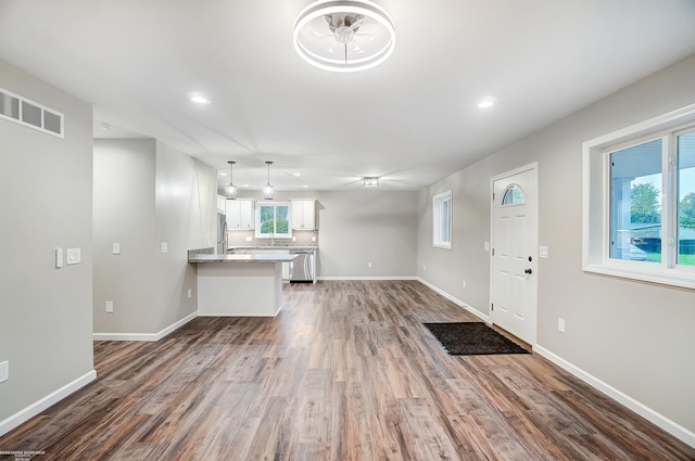 unfurnished living room with dark hardwood / wood-style flooring