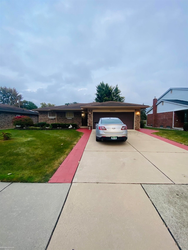 ranch-style home with a front yard and a garage