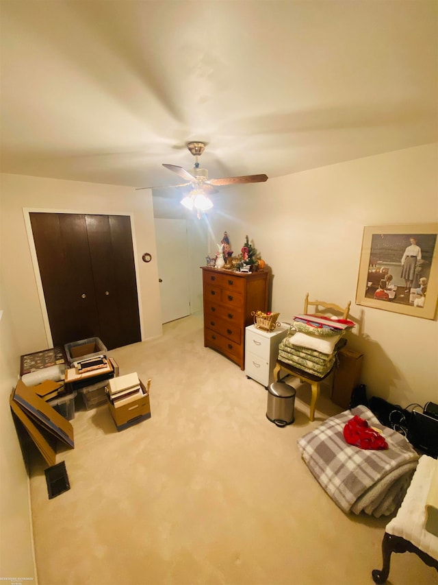 interior space with light carpet and ceiling fan