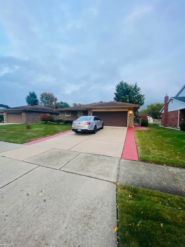 view of front of home featuring a garage and a front lawn