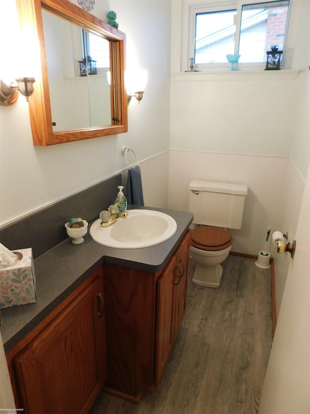 bathroom with vanity, hardwood / wood-style floors, and toilet