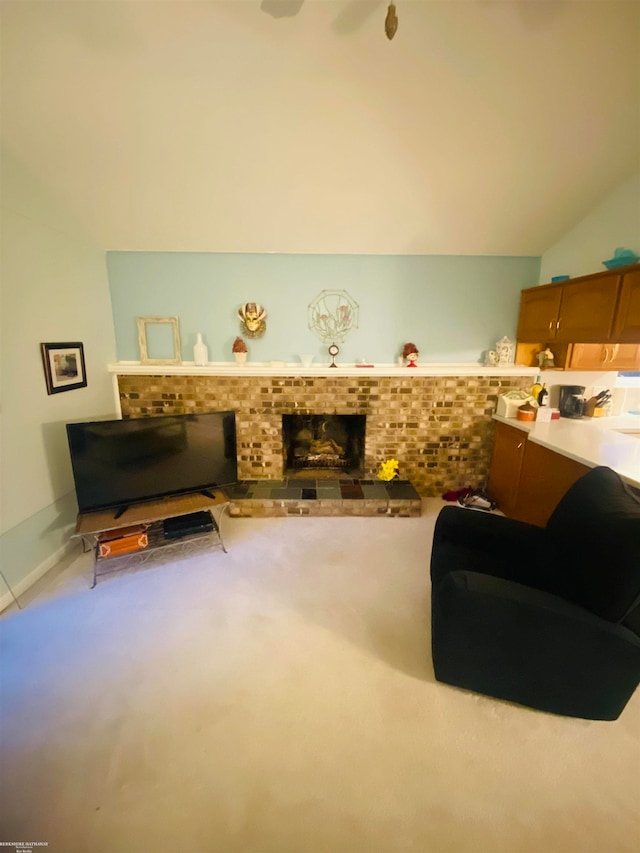 carpeted living room with lofted ceiling and a brick fireplace