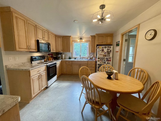 156 N Carlshend Rd, Skandia, MI 49885 - kitchen featuring electric range, light countertops, an inviting chandelier, and freestanding refrigerator