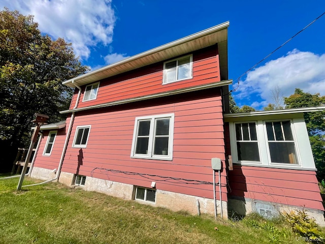 view of side of home with a lawn