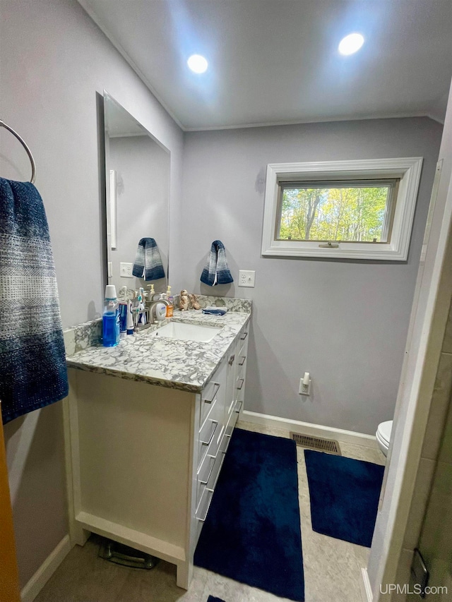 bathroom featuring vanity and toilet