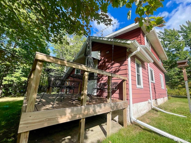 exterior space featuring a wooden deck and a yard