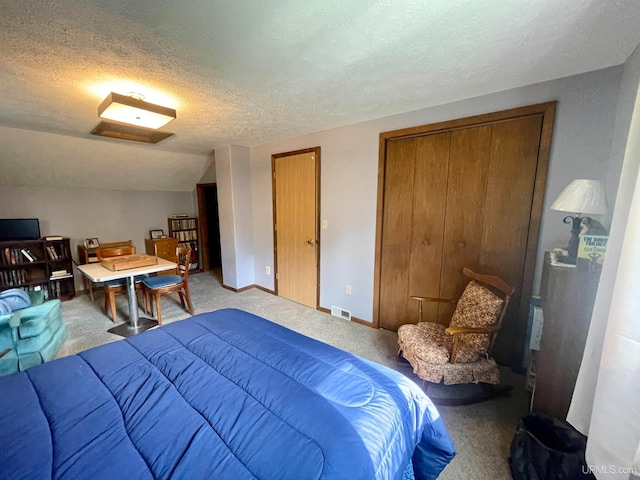 bedroom featuring carpet floors, a textured ceiling, and vaulted ceiling