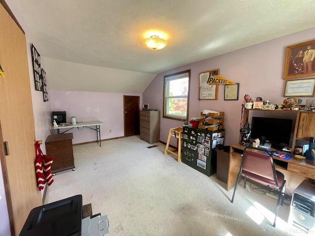 home office featuring a textured ceiling, vaulted ceiling, and carpet